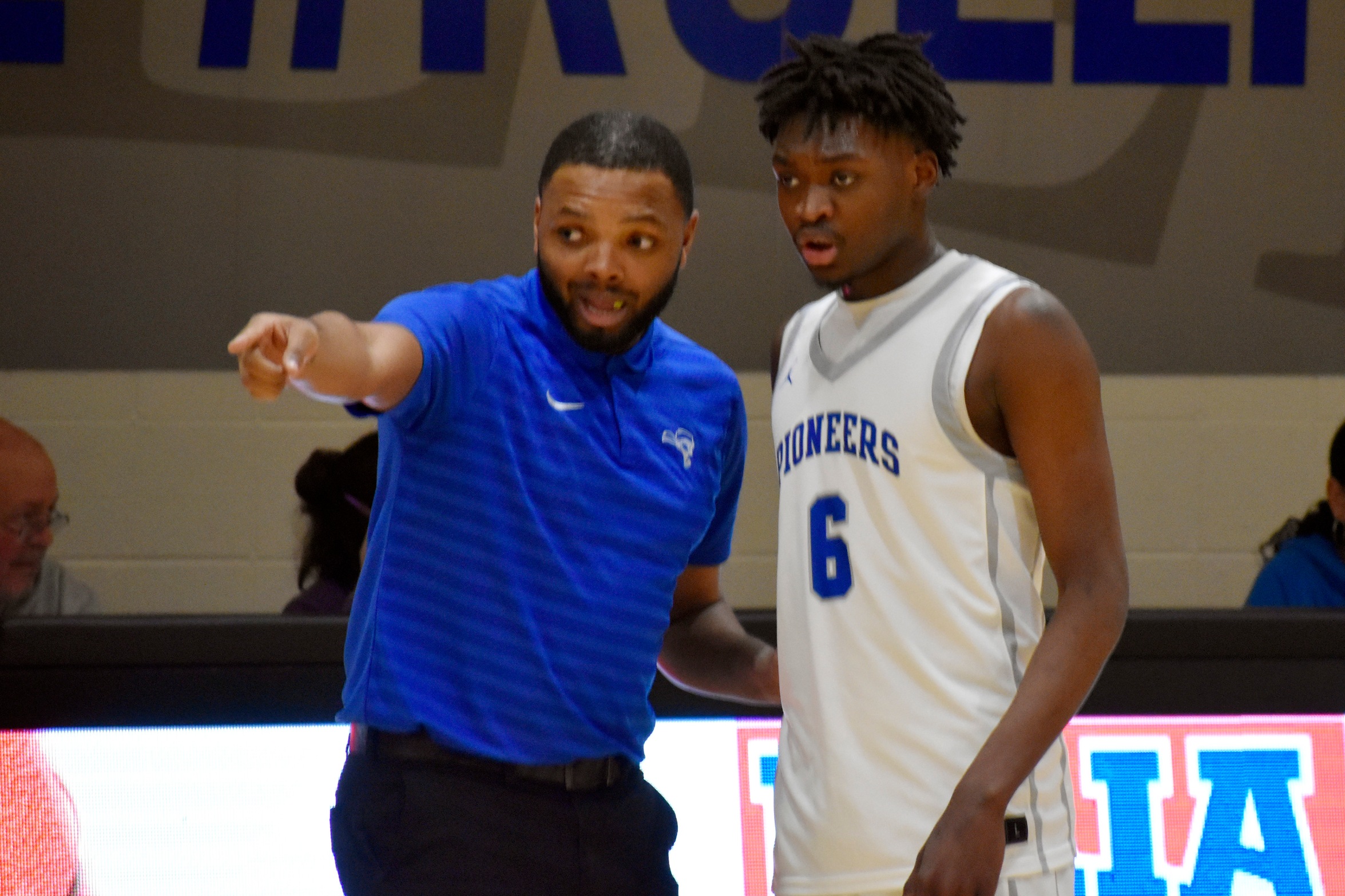 Head Coach Blake Jackson gives instructions to Richard Rojas, who had a double double. Photo by Tristan Craine, SMC Sports Communications